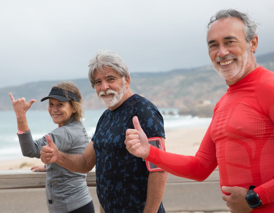 Senior friends exercising together outdoors